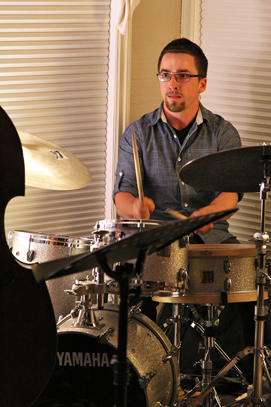 The Soren Nissen, Ian Wright and Nate Renner trio. Ian Wright looking serious during a drum solo, with Nissen's bass just visible in the foreground. Photo taken Friday, May 17, 2013.